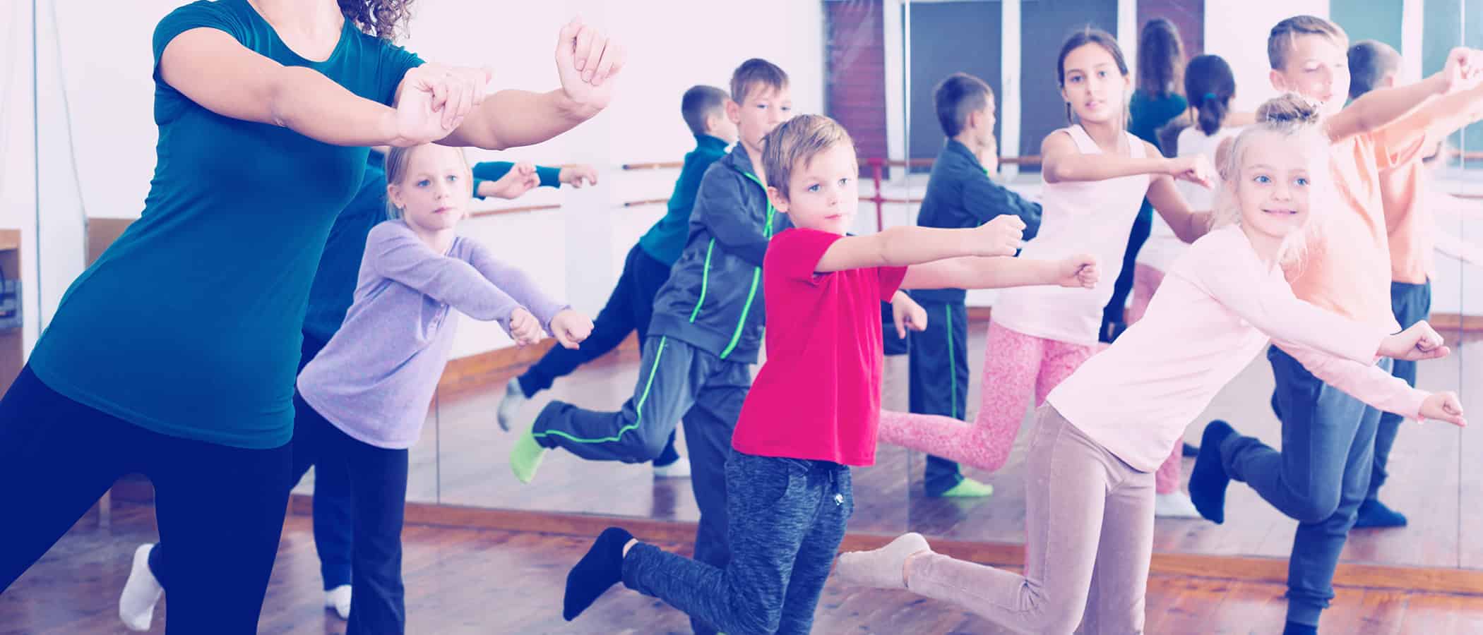 Little children studying modern style dance in class