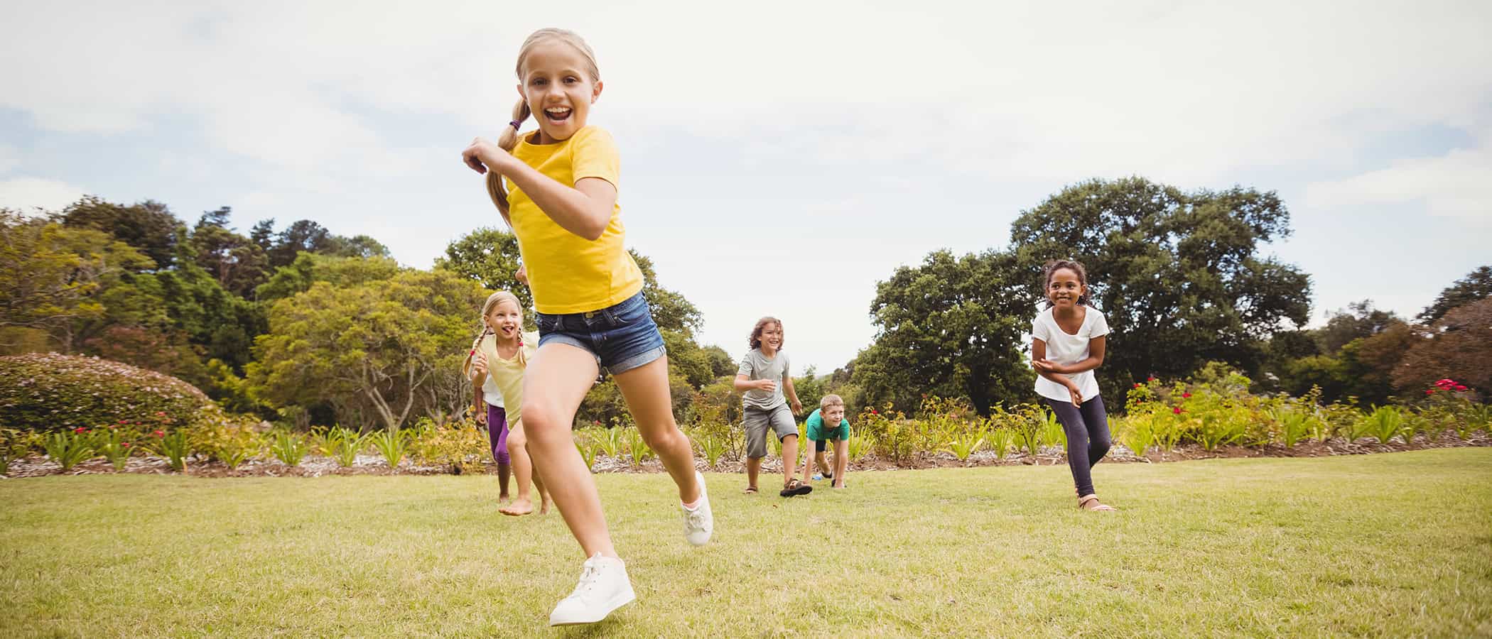 Facing view of children running in the park