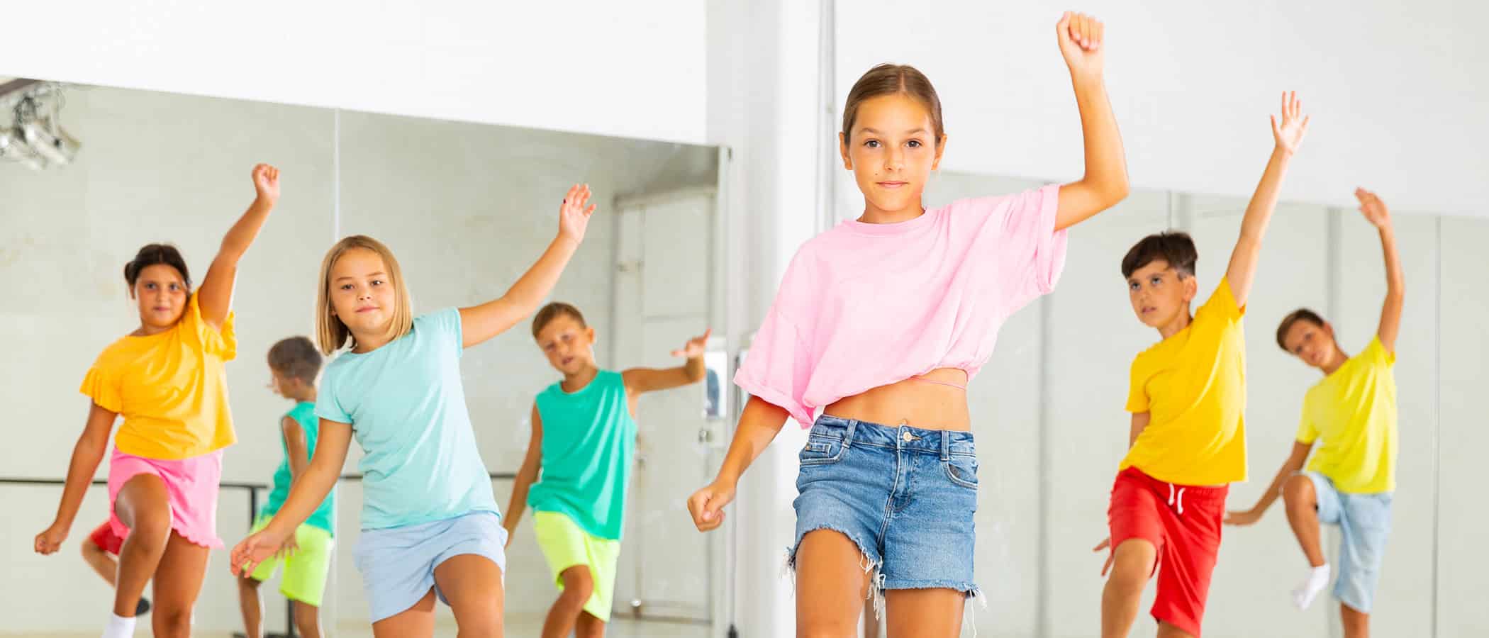 Happy kids having fun in a choreography studio during dance lesson