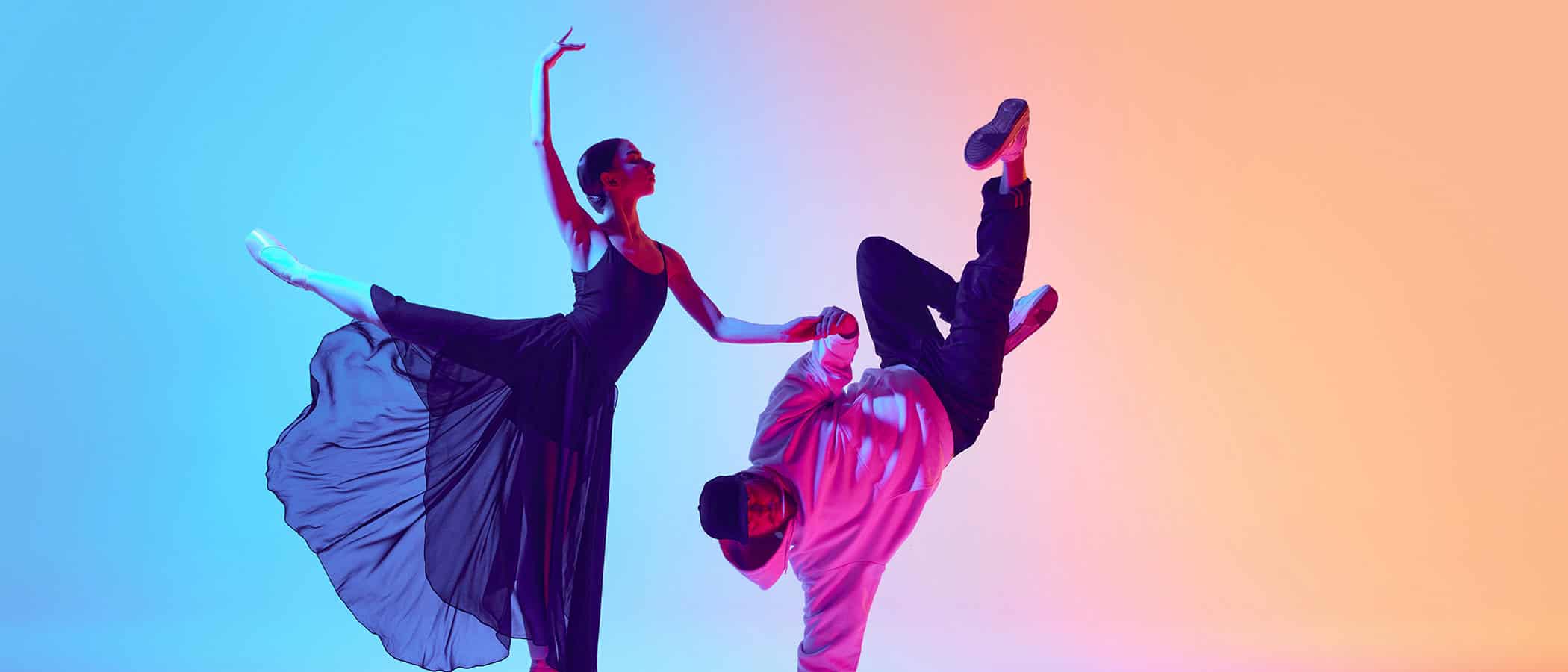 Ballet and street dance mix. Beautiful young girl in black dress, ballerina dancing with young man, hip hop performer on gradient background in neon. Concept of classical and modern dance, performance